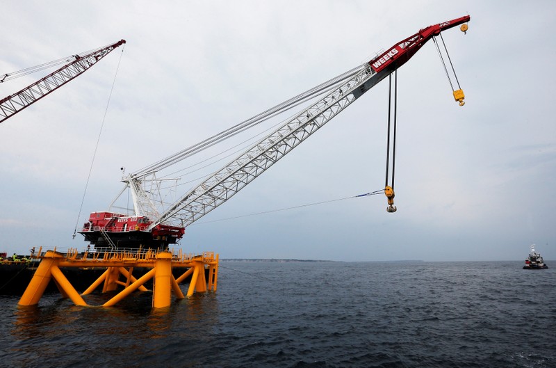 FILE PHOTO: Crane hangs over the first jacket installed to support a turbine for a wind farm in