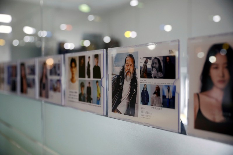 Profile picture of South Korean senior model Kim Chil-doo, 65-years-old, hangs on a glass wall