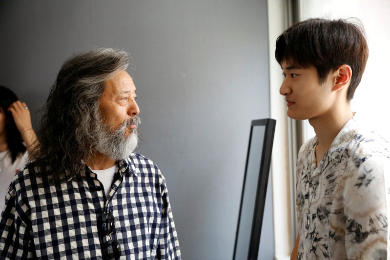 South Korean senior model Kim Chil-doo, 65-years-old, talks with a model during a practice