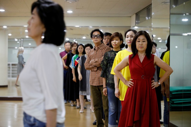 Middle-aged people attend a senior model class in Seoul