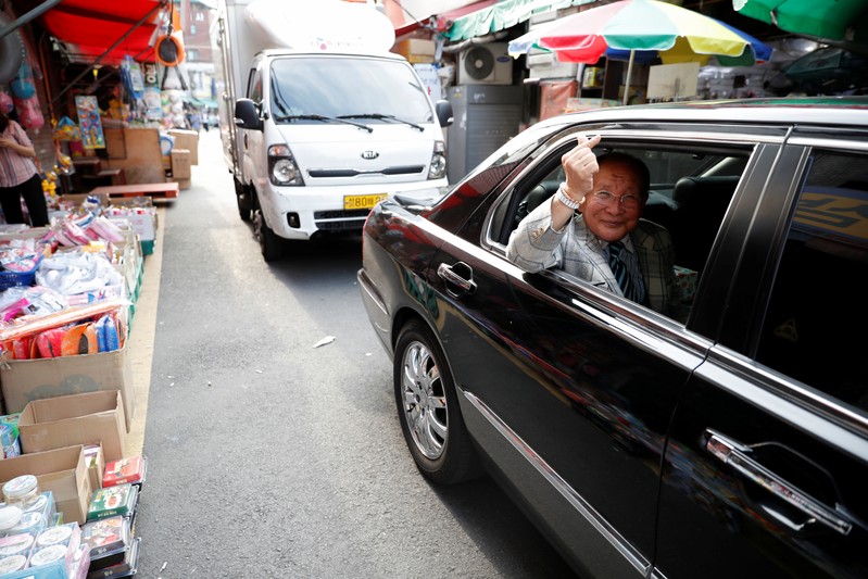 Ji Byung-soo, 77-year-old, a South Korean celebrity, poses for photographs as he leaves a toy
