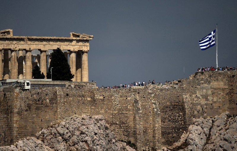 FILE PHOTO: Greek flag flutters in front of the ancient Parthenon temple atop the Acropolis