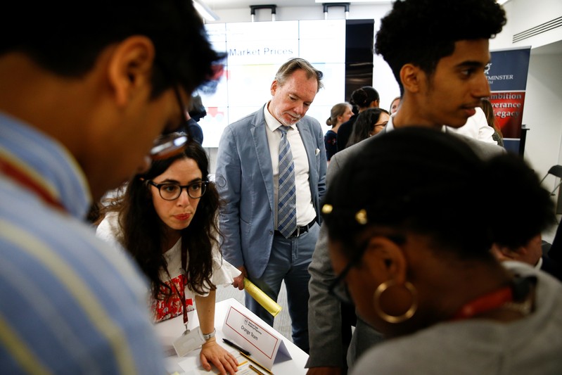 Britain's Chief Trade Negotiation Adviser Crawford Falconer watches students take part in a