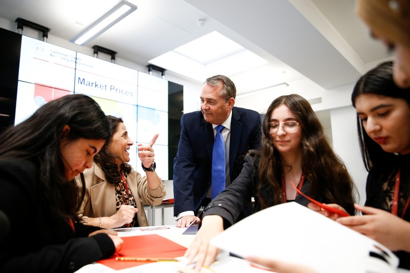 Britain's Secretary of State for International Trade Liam Fox visits students taking part in a