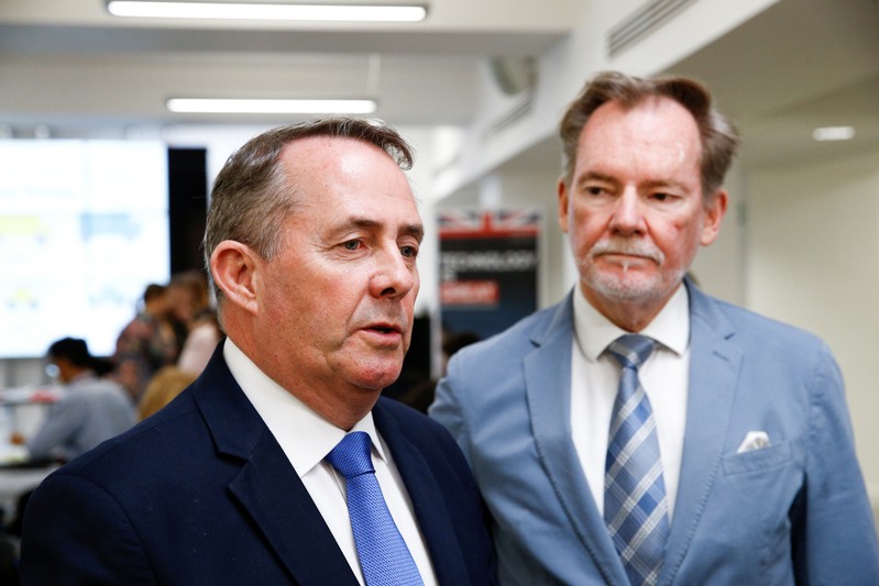 Britain's Secretary of State for International Trade Liam Fox speaks next to Britain's Chief