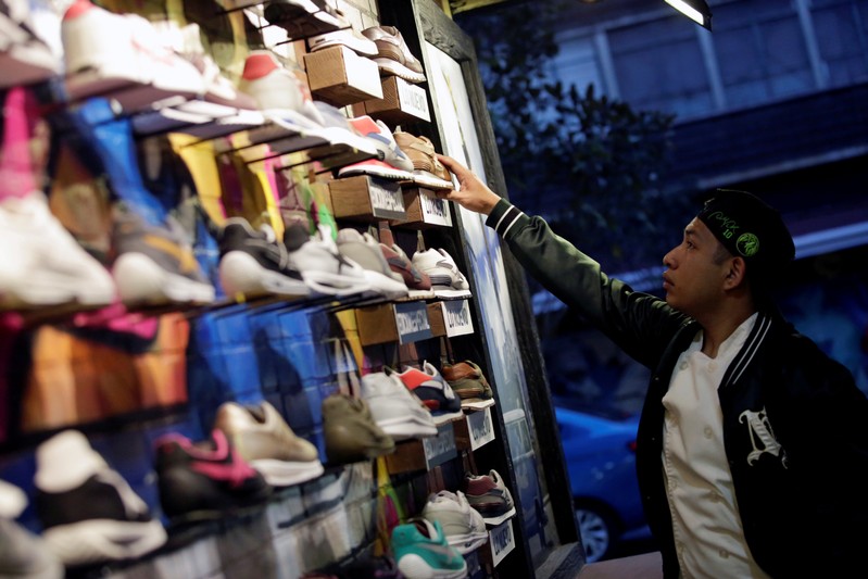 FILE PHOTO: A costumer looks at shoes at a shoe store in Mexico City