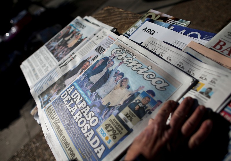 Newspapers are displayed over a table one day after the primary elections, in Buenos Aires