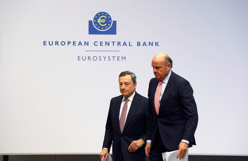 FILE PHOTO: European Central Bank President Draghi and Vice-President de Guindos leave a news