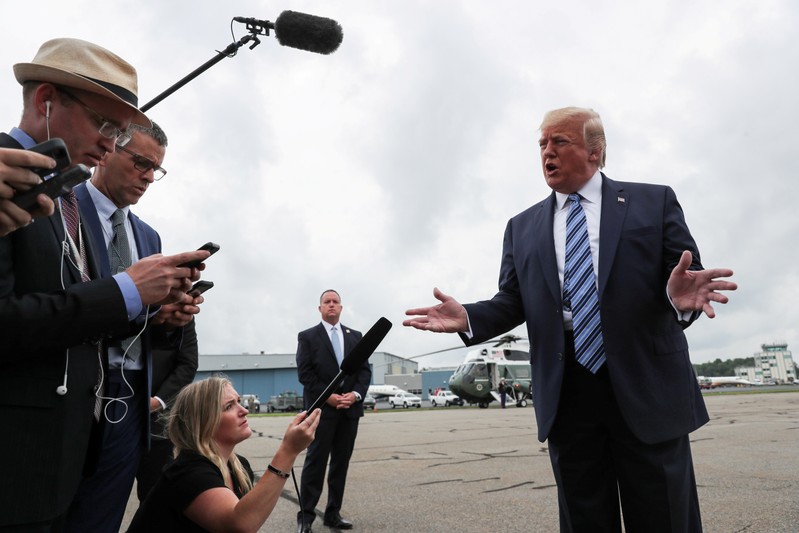 FILE PHOTO: U.S. President Trump talks to reporters as he boards Air Force One for travel to