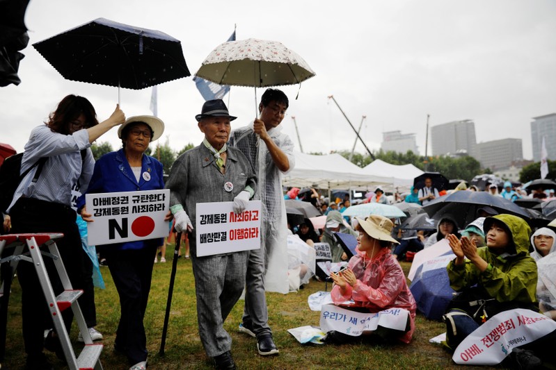 Lee Choon-shik, a victim of wartime forced labor during the Japanese colonial period, holds a