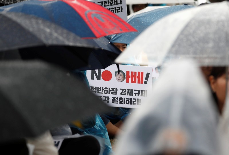 A woman holds a banner that reads 