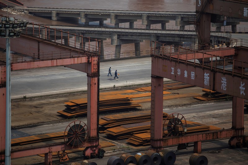 Workers walk at a dock dedicated for Chongqing Iron and Steel on the Yangtze river in Changshou