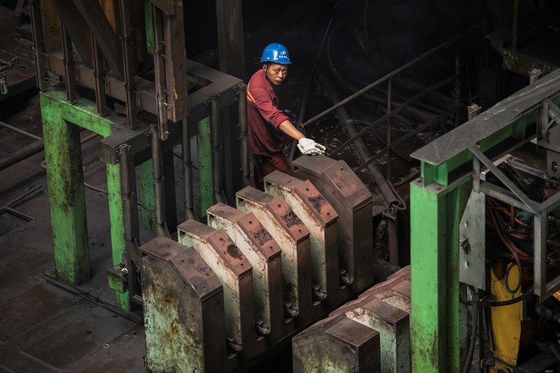 Worker is seen at a hot rolling production line at the Chongqing Iron and Steel plant in