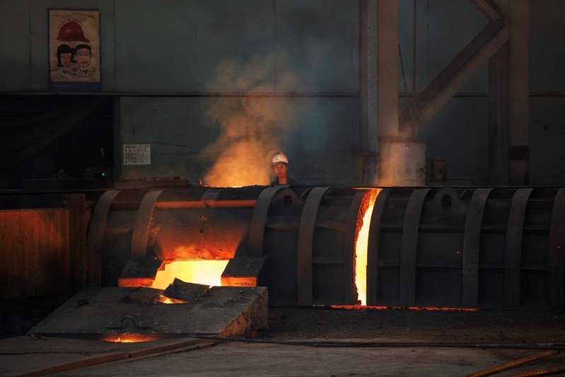 Worker works by a blast furnace at the Chongqing Iron and Steel plant in Changshou