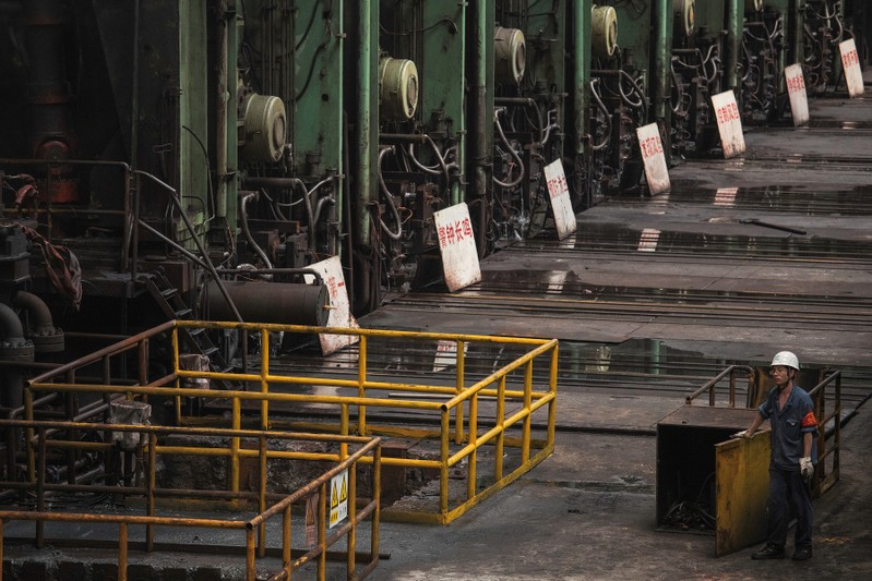 Worker is seen at a hot rolling production line at the Chongqing Iron and Steel plant in