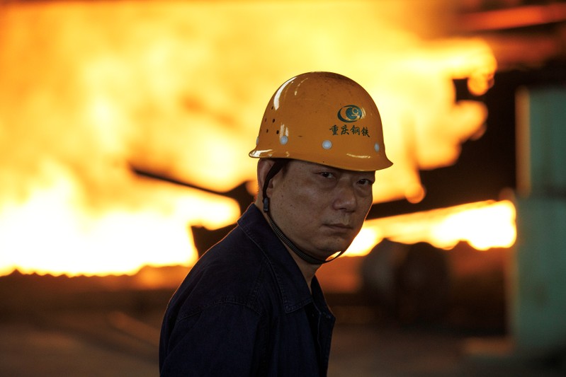 Worker looks on in front of a blast furnace at the Chongqing Iron and Steel plant in Changshou