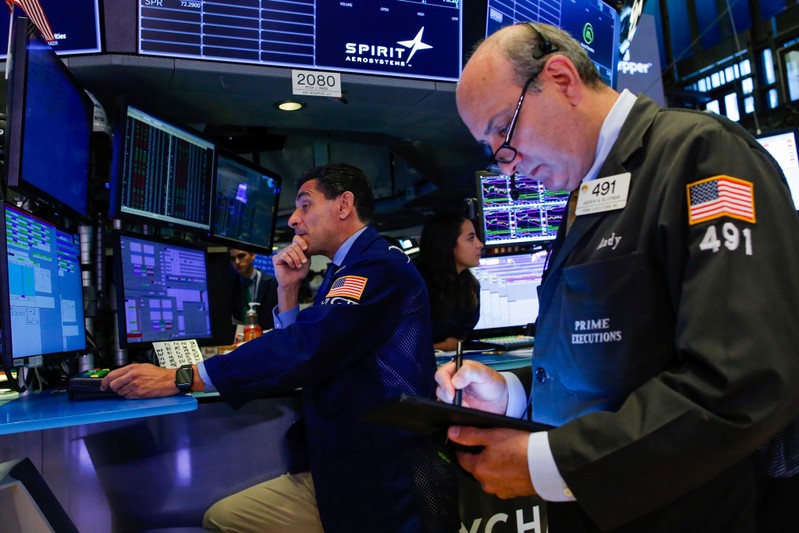 Traders work on the floor at the New York Stock Exchange (NYSE) in New York