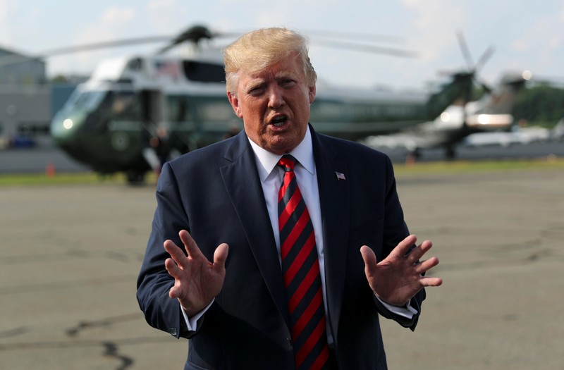 U.S. President Donald Trump speaks to reporters before boarding Air Force One to return to