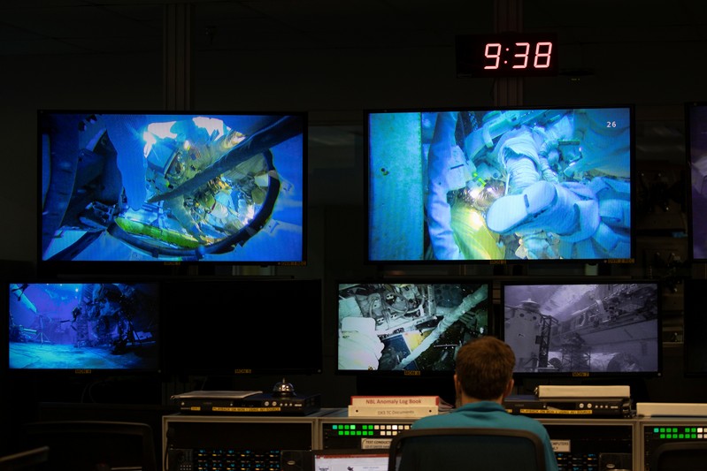 A control room full of video screens keeping watch over the underwater training at NASA's
