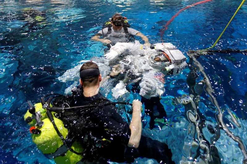 NASA Commercial Crew astronaut Sunita Williams enters the water at NASA's Neutral Buoyancy