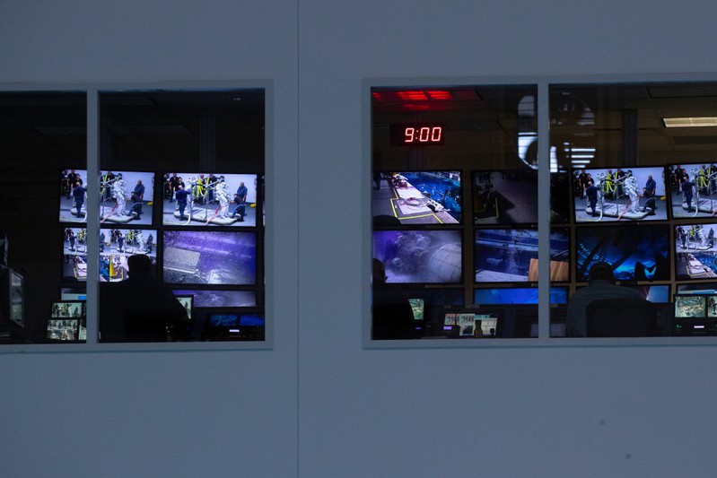 A control room full of video screens keeping watch over the underwater training at NASA's