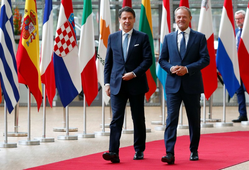 Italian PM Conte walks with EU Council President Tusk in Brussels