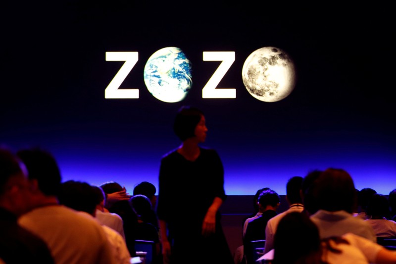 FILE PHOTO: A woman is seen in front of a sign reading Zozo, which operates Japan's popular