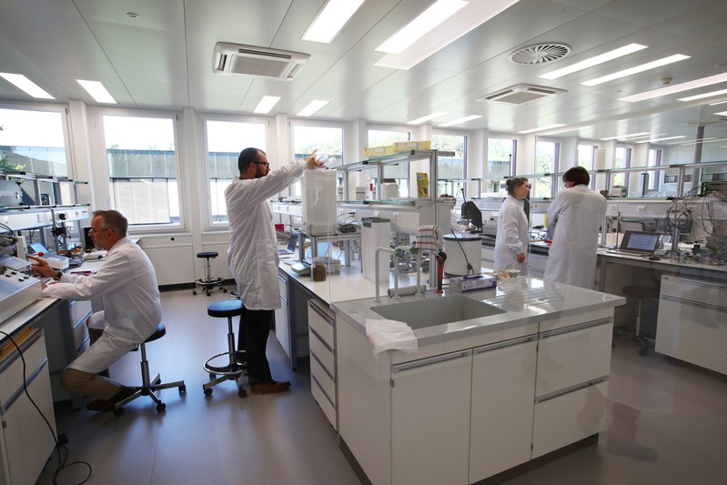 Staff work in a laboratory during a media visit for the inauguration of the Nestle Institute of