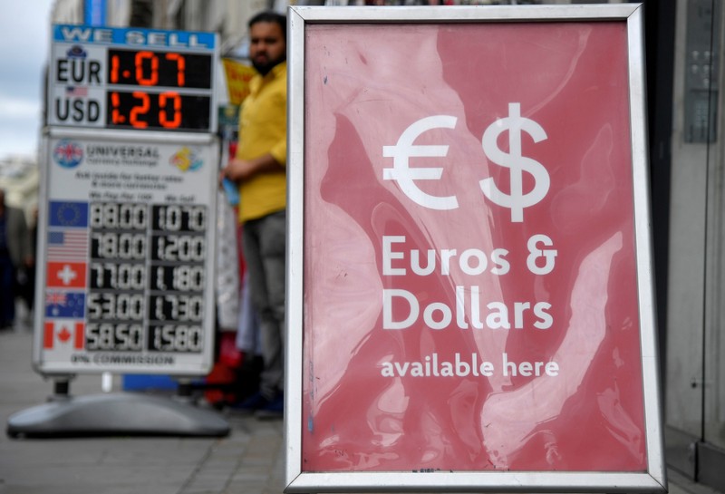 FILE PHOTO: Boards displaying buying and selling rates are seen outside of currency exchange