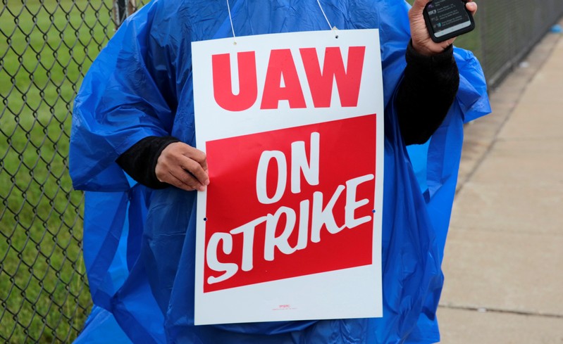 Member of United Auto Workers, Aramark workers, carries a strike sign outside the General