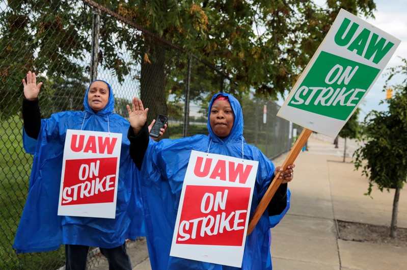 United Auto Workers, Aramark workers, carry strike signs outside the General Motors