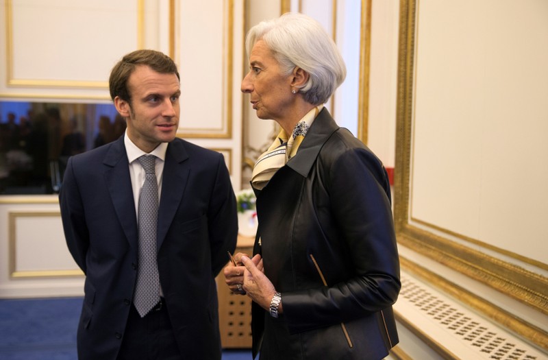 FILE PHOTO: Lagarde speaks with Macron during a meeting with international economic