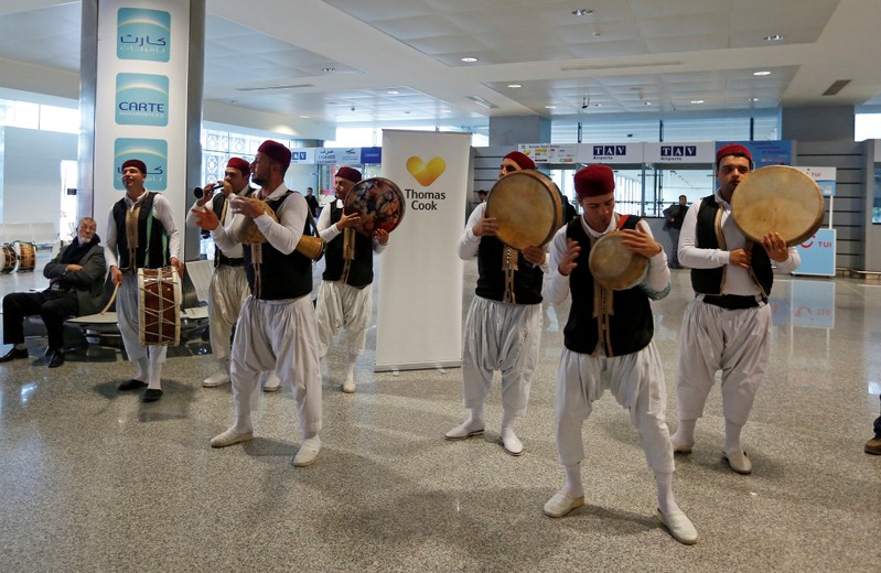 FILE PHOTO: Members of a traditional music group perform as tourists traveling with the Thomas