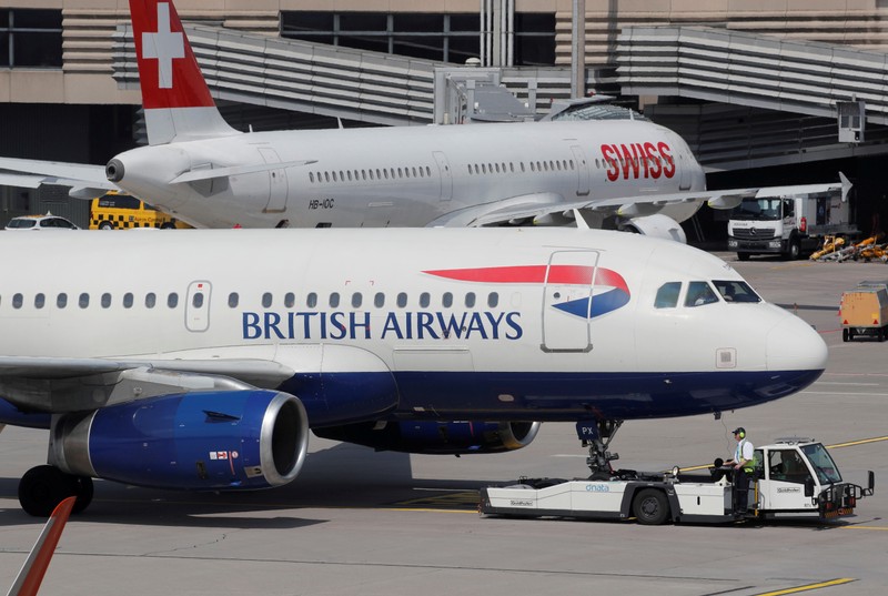 An aircraft of British Airways airlines is pulled by a Goldhofer pushback tractor of air
