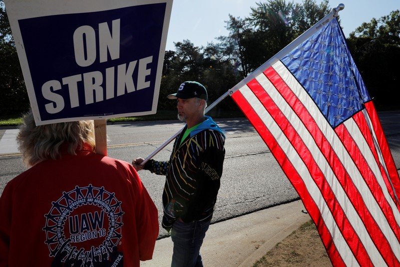 Striking union workers walk the picket line outside the GM Flint Truck Assembly in Flint