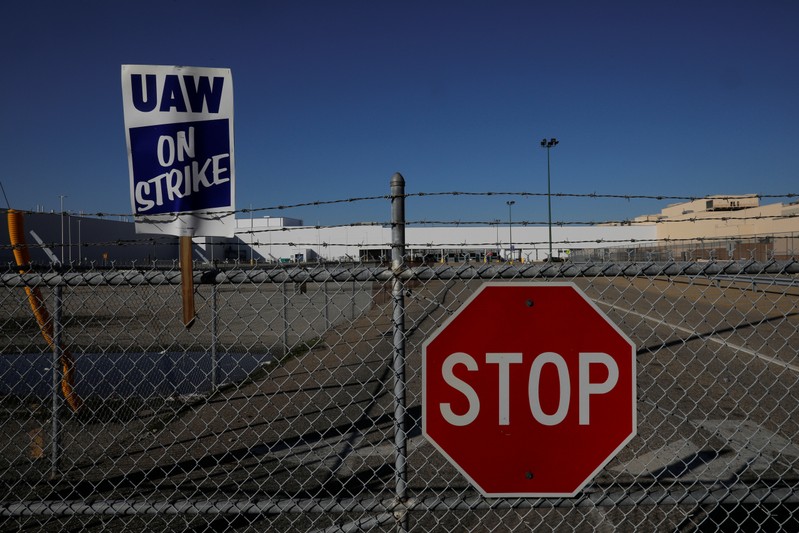 A union strike sign is stuck in the fence outside the GM Flint Truck Assembly in Flint