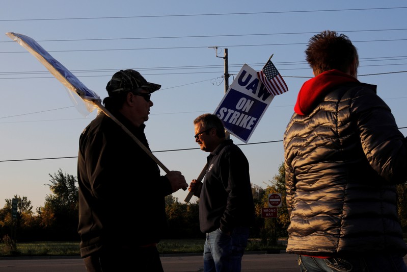 Striking union workers walk the picket line outside the GM Flint Truck Assembly in Flint