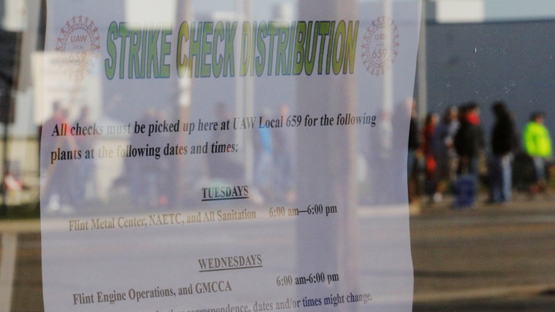 A window with the strike check distribution schedule reflects the picket line outside the GM