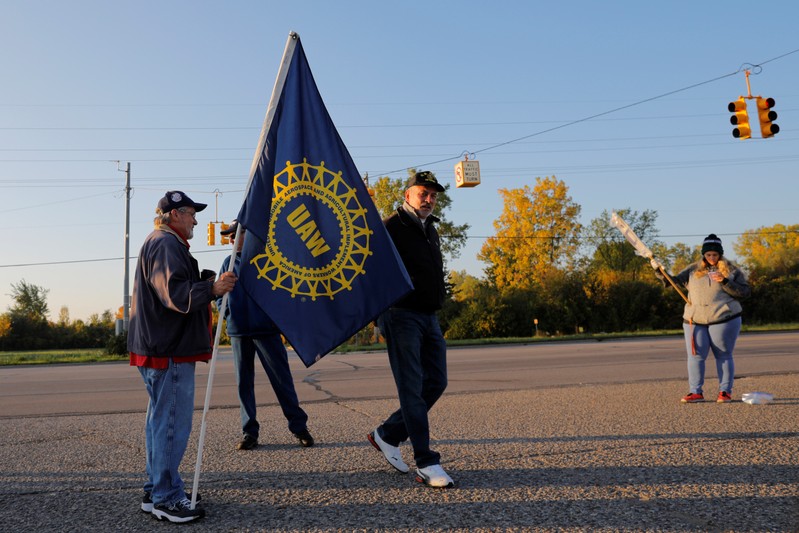 Striking union workers walk the picket line outside the GM Flint Truck Assembly in Flint