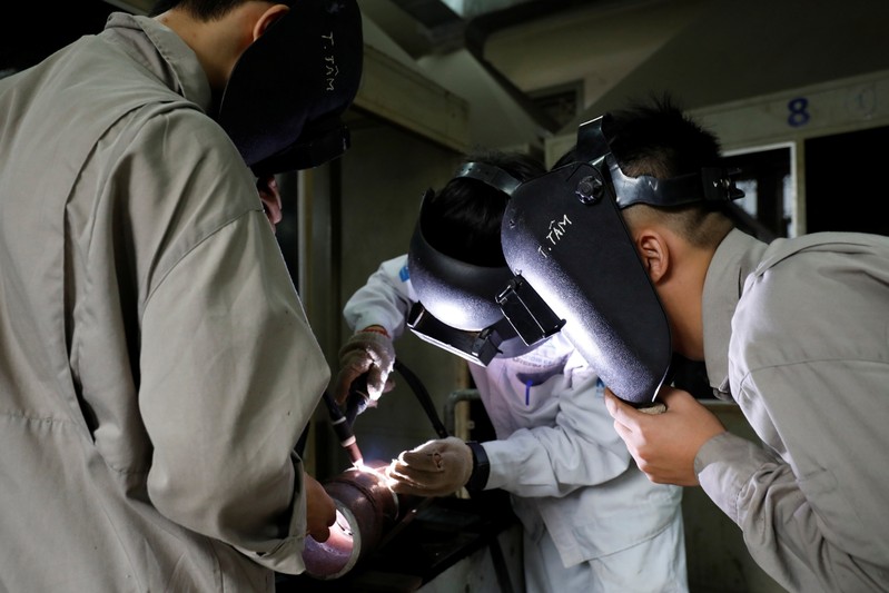 Students practise at a lab of an industrial vocational training college in Hanoi