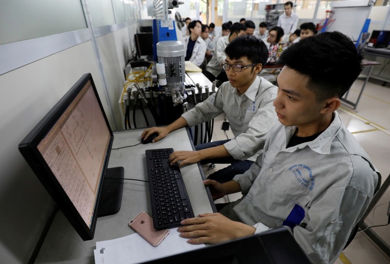 Students practise at a lab of an industrial vocational training college in Hanoi