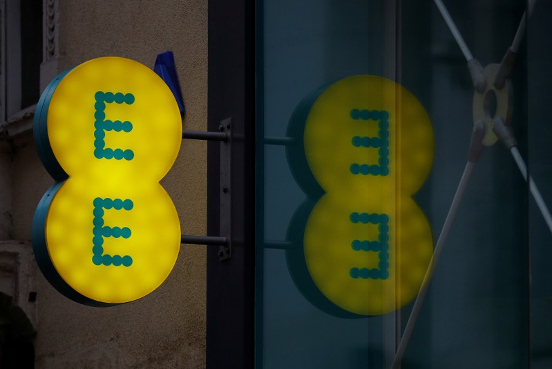 Signage is seen outside an EE mobile phone shop in Manchester