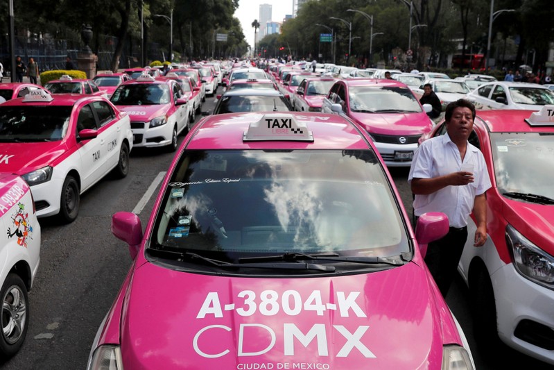 FILE PHOTO: Taxi drivers hold a protest against taxi-hailing apps such as Uber, Cabify and