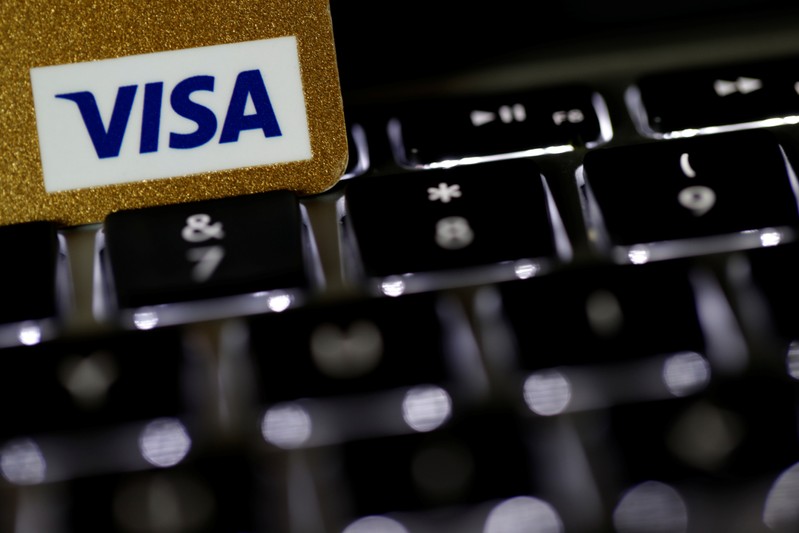 A Visa credit card is seen on a computer keyboard in this picture illustration