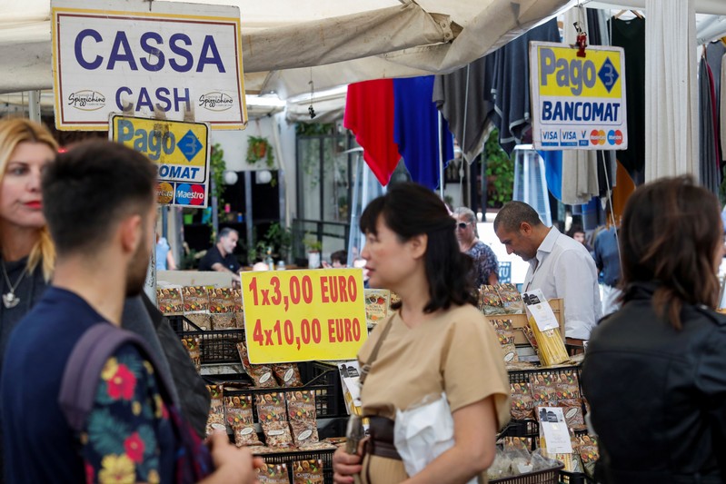 People walk at the market in downtown Rome as Italy's cabinet prepares to approve a 2020 budget