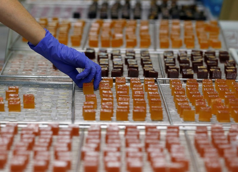 A worker prepares boxes of glace fruits and fruit jelly for export at the Cruzilles factory in