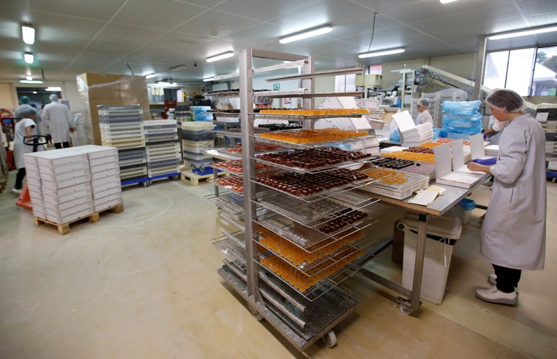 A worker prepare boxes of glace fruits and fruit jelly to export to England at the Cruzilles