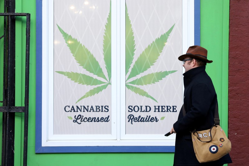 FILE PHOTO: A man walks past a sign outside the Natural Vibe store after legal recreational