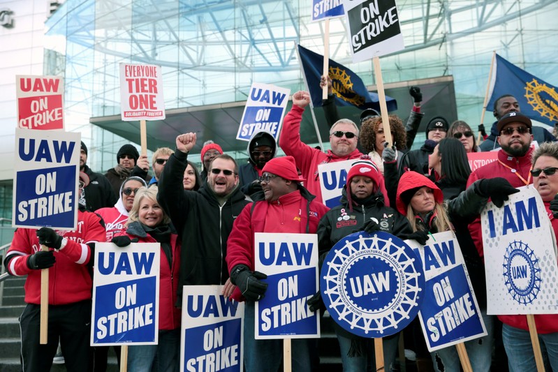 Striking United Auto Workers (UAW) members rally in front of General Motors World headquarters