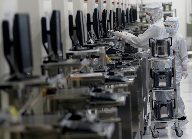 FILE PHOTO: Employees of Austrian sensor specialist AMS work in their factory in